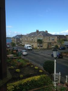 a view of a street with cars parked on the road at Charles's Street in Largs