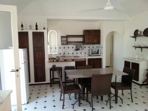 a kitchen with a table and chairs in a room at Villa Jeko in Lampedusa