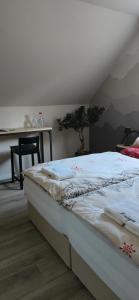 a bed sitting in a room with a table at La Re Source Chambres et table d'hôtes in Villers-le-Lac