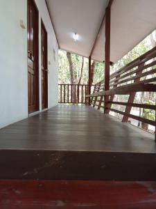an empty porch of a house with a wooden deck at Forest Park Resort สังคม หนองคาย in Sangkhom