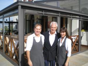 two men and a woman standing in front of a building at Antica Dogana in Cavallino-Treporti