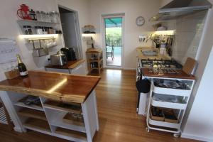 a kitchen with a counter and a stove top oven at Spot the Sea eagle in Woodbridge +2 photos