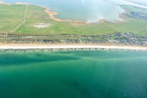 an aerial view of a beach with a fire in the distance at Ferienhaus Kranich in Pruchten