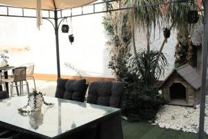 a patio with a table and chairs and a dog house at Trudy's home in Nicosia