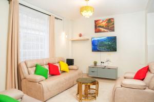 a living room with a couch and two chairs at Shalom Haven in Naivasha