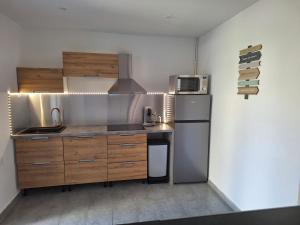 a kitchen with a sink and a refrigerator at Calanques de Sormiou in Marseille