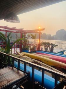 a group of surfboards are lined up next to the water at Eco Floating Stay Cai Beo in Cat Ba +36 photos