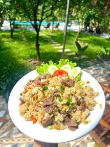 a white plate of food on a table at Peaceful Garden Tam Cốc in Văn Lâm