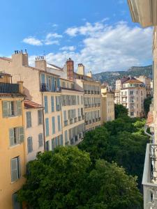a group of buildings in a city with trees at T3 Chaleureux - Vieux Toulon - Proche Port in Toulon