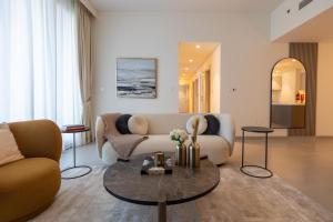 a living room with a couch and a table at Luxury 3BR plus Storage in Forte Downtown in Dubai