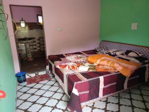 a bedroom with a bed in a room with a mirror at Khoyal home stay in Jāmb