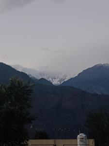 a view of a mountain with a snow covered mountain at Khoyal home stay in Jāmb