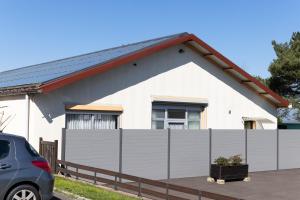 a white house with a fence in front of it at Loft touristique 3 étoiles in Dannemarie