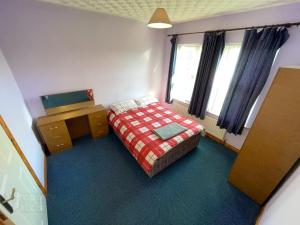 a small bedroom with a bed and a window at Causeway holiday home in Ballycastle +7 photos