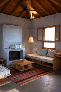 a living room with a couch and a fireplace at eumelia organic agrotourism farm in Goúvai