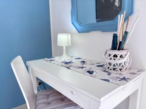 a white table with a lamp on top of it at Blue apartment, Alghero, near beaches in Alghero