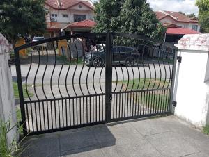 a black gate with a car parked in a driveway at have fun staying here in Kuala Lumpur