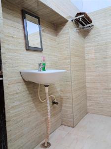 a bathroom with a white sink in a room at LD Guest House, Ayodhya in Ayodhya
