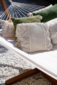 a white bed with pillows on top of rocks at La Garoupe-Gardiole in Antibes