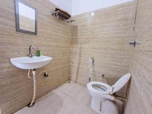 a bathroom with a toilet and a sink at LD Guest House, Ayodhya in Ayodhya