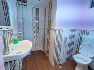 a bathroom with a toilet and a sink at LD Guest House, Ayodhya in Ayodhya