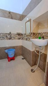a bathroom with a sink and a toilet at LD Guest House, Ayodhya in Ayodhya