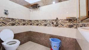 a bathroom with a toilet and a sink at LD Guest House, Ayodhya in Ayodhya