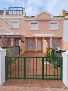 a house with a gate in front of it at Villa Terreros 67 in San Juan de los Terreros