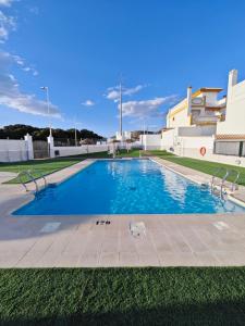a large swimming pool in front of a building at Villa Terreros 67 in San Juan de los Terreros