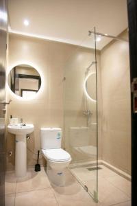 Un baño con inodoro, lavabo y ducha. en Amira luxury home, en Martil