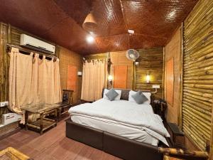 a bedroom with a bed and a table in a room at Tourist pure veg Hotel And Restaurant in Lansdowne