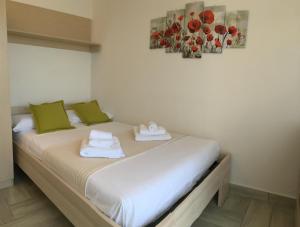 a bed in a room with two towels on it at SunSea in Calatabiano