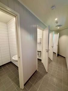 a bathroom with a toilet and a sink at Trollstigen Camping and Gjestegård in Åndalsnes +10 photos