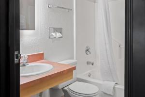 a white bathroom with a sink and a toilet at Super 8 by Wyndham Santa Rosa in Santa Rosa +62 photos