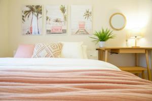 a bedroom with a bed and a table with a mirror at Li Kotohogi 4F,5F in Naha