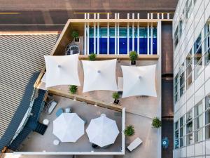 an overhead view of a building with tables and umbrellas at The Olsen Melbourne Art Series in Melbourne