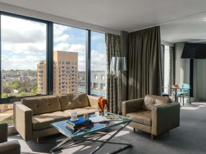 a living room with a couch and a glass table at The Olsen Melbourne Art Series in Melbourne