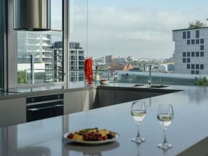 a table with two glasses of wine and a plate of food at The Olsen Melbourne Art Series in Melbourne