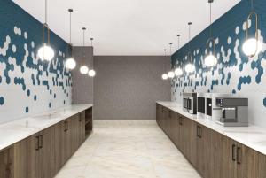 a large room with counters and a wall with birds painted on it at La Quinta Inn & Suites by Wyndham Mebane in Mebane
