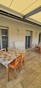 a large room with a table and chairs and a bed at Quarantotto B&B in Raffa