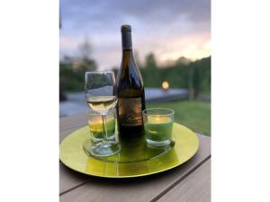 a bottle of wine and two glasses on a table at Marina Strandbad Chalet SunnyTides Haus Nr 36 in Olburgen