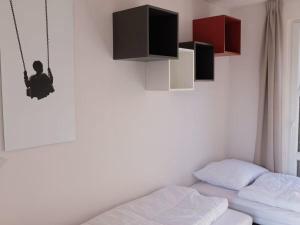 a bedroom with a bed and a swing at Marina Strandbad Chalet SunnyTides Haus Nr 36 in Olburgen +15 photos