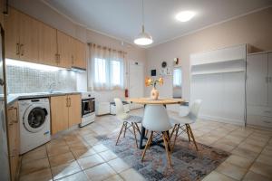 a kitchen with a table and chairs in a room at Corfu Asonitis Apartment in Ermones