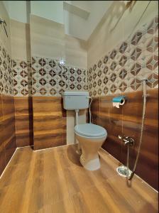 a bathroom with a toilet and a shower at Calm and Cozy- Tffstays in Lucknow