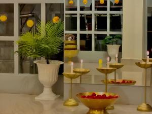 a room with several vases and candles on display at Calm and Cozy- Tffstays in Lucknow +9 photos
