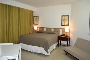 Ένα ή περισσότερα κρεβάτια σε δωμάτιο στο Aparta Hotel Plaza del Sol