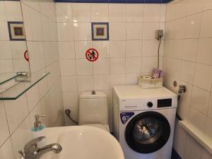 a bathroom with a washing machine and a washer at Elena's 3BR Maisonette with Garden & Pool in Nea Plagia +34 photos