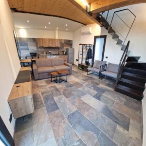 an open living room with a couch and a kitchen at Dimore d'Oltremare - Appartamento Libeccio in Lavagna