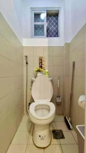 a bathroom with a white toilet with a window at Casa Esperanza 1376 in Dauis