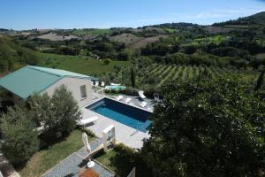 an aerial view of a villa with a swimming pool at Le Cune, Apt Cipressino - AC, Pool & Jacuzzi in Palazzo